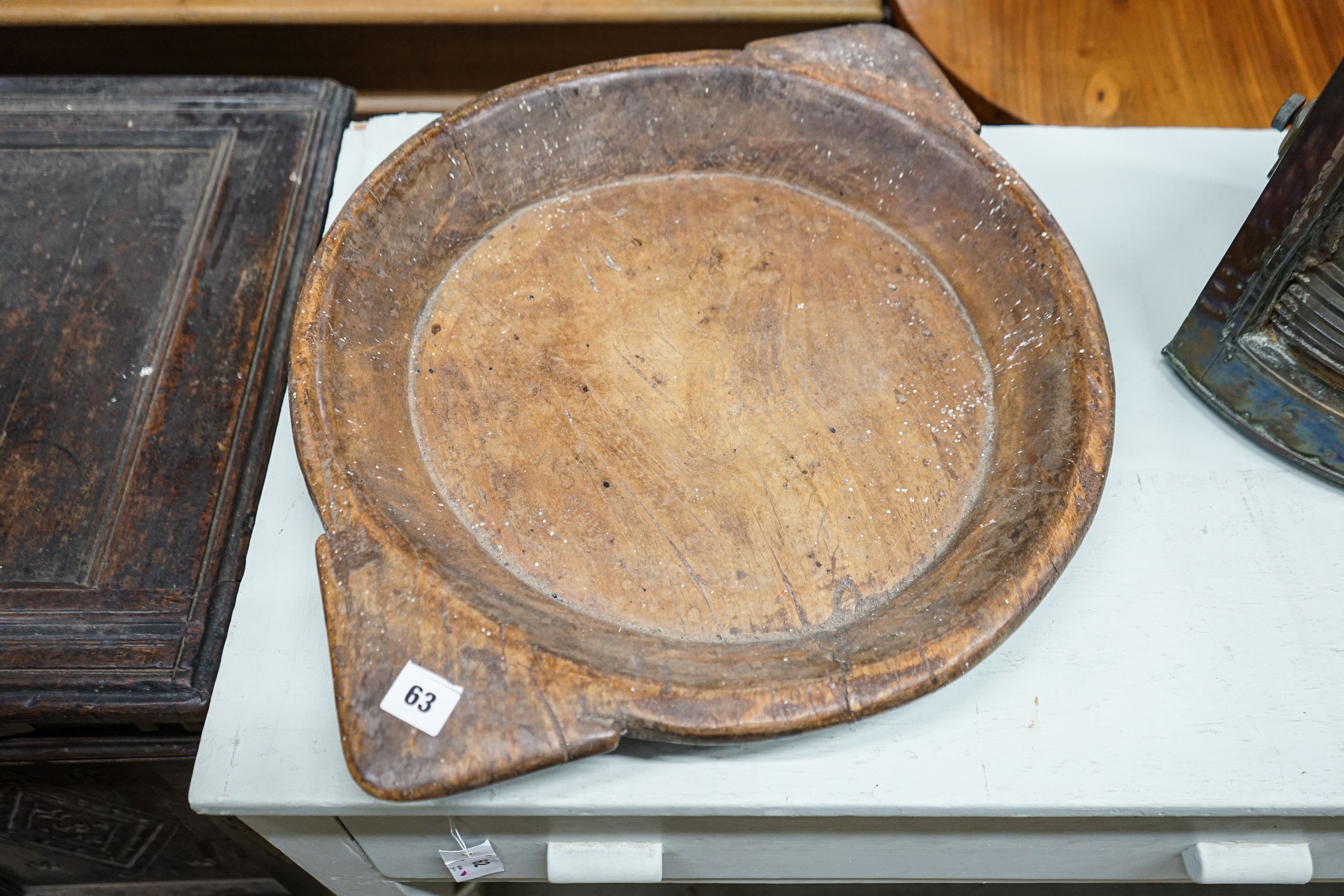 An early 19th century sycamore shallow bowl with lug handles, 64cm and two other bowls, 40cm and 26cm